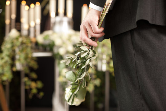 Grief - Man With White Roses At Urn Funeral