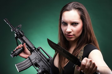 Fototapeta na wymiar Sexy young woman long hair - gun knife