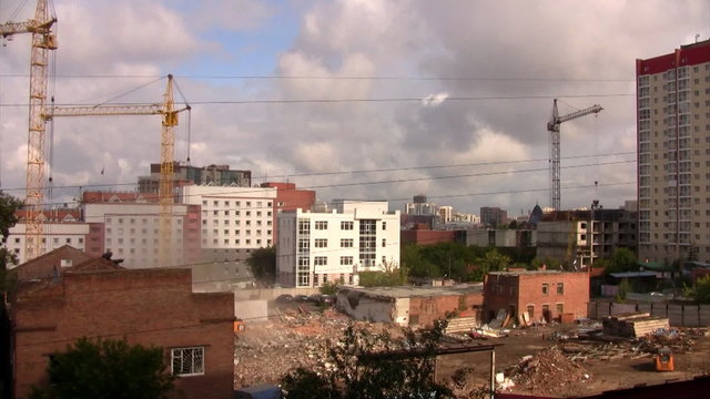 Time lapse view of the construction site with three cranes
