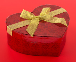 Heart shaped gift box on red background
