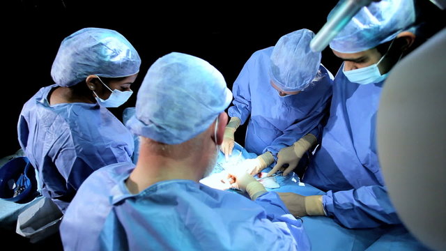 Overhead View Multi Ethnic Surgical Team in Operating Theater