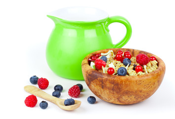 cornflakes with a jug of milk and fruits, on white background