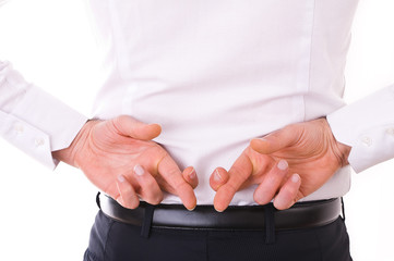 Business man with fingers crossed.