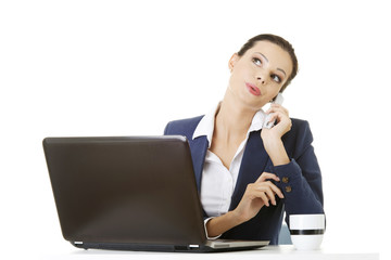Smiling young business woman speaking on phone