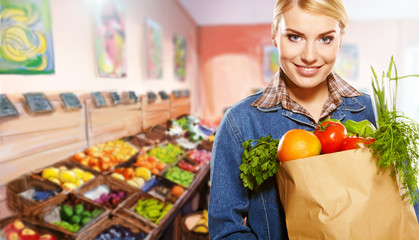 woman shopping for fruits and vegetables in produce department o
