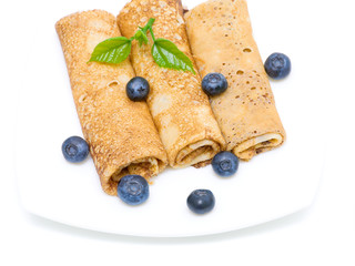 pancakes and fresh blueberries on a white background