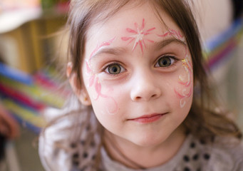 little girl with faceart on birthday party