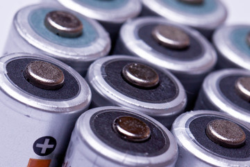 Several AA batteries in perspective closeup view on white backgr