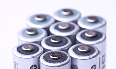 Several AA batteries in perspective closeup view on white backgr
