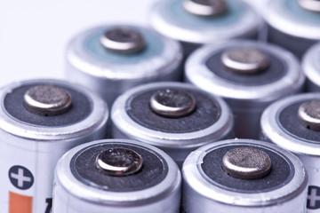Several AA batteries in perspective closeup view on white backgr