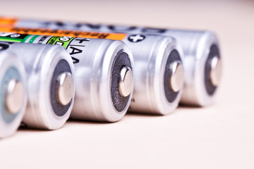 Several AA batteries in perspective closeup view on white backgr