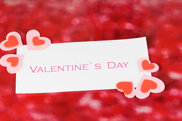 Fototapeta na wymiar Greeting card for Valentine's Day on red background