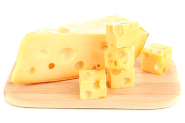 Cut cheese on wooden board isolated on white