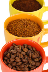 Different types of coffee in three cups isolated on white