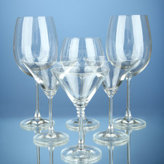 Cocktail and wine glasses, on blue background