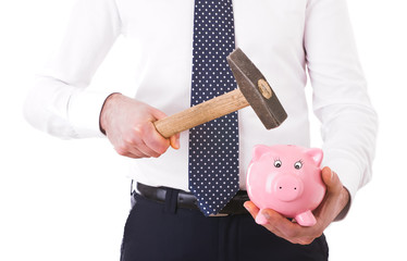 Businessman with piggy bank and hammer.