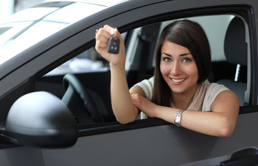 Fototapeta na wymiar Happy smiling woman with car key. Driving