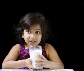 A cute girl drinking milk