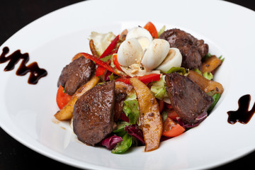 Fresh salad with meat and quail eggs