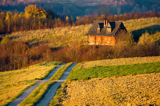 Fototapeta Cottage house in autumn fields