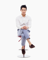 Naklejka premium Young Asian person sitting on the chair.