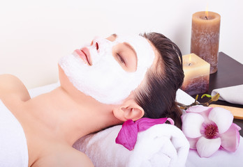 Beautiful girl receiving pink facial mask