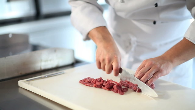 hands cutting fresh meat