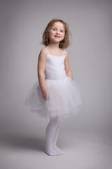 Little blond girl in a ballet dress