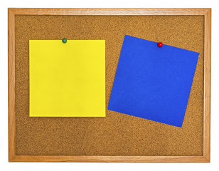 Yellow and blue note papers pinned on cork board