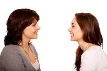 Mother and teenage daughter talking and laughing together.