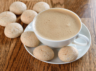 Amaretto cookies with a cappuccino on a brown table