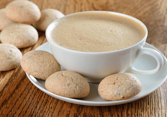 amaretti  cookies with a cappuccino on a brown table