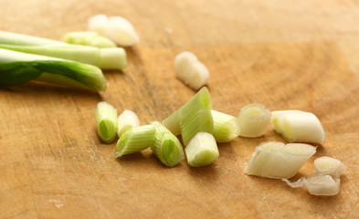 Chopped spring onions on preparation table