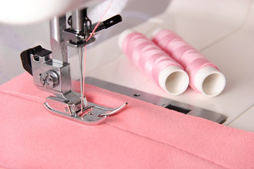 sewing process of rosy cloth on the machine and two bobbins
