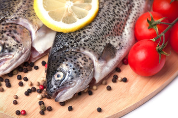 Trout on wooden plate isolated over white