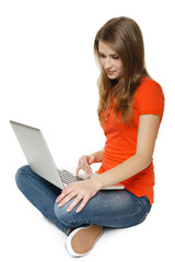 Young woman sitting on the floor while using her laptop