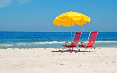 Beach chairs and umbrella on beach in Rio de Janeiro
