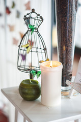 Composition with ornament, candle and butterfly 