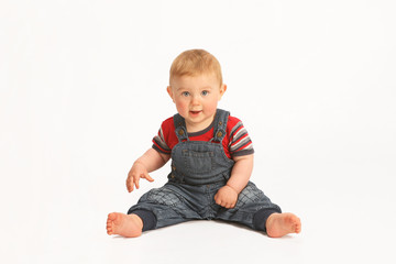 Cute baby sitting on white background
