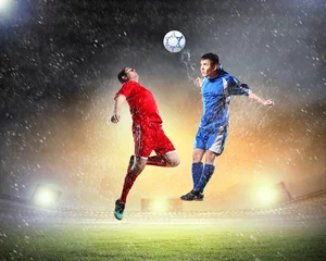 Afwasbaar Fotobehang Voetbal twee voetballers die de bal slaan