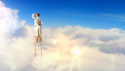 Businesswoman standing on ladder © Sergey Nivens