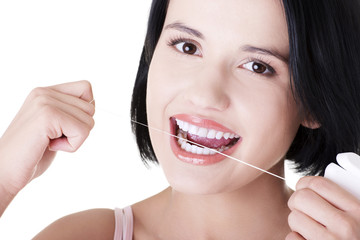 Beautiful  woman using dental floss