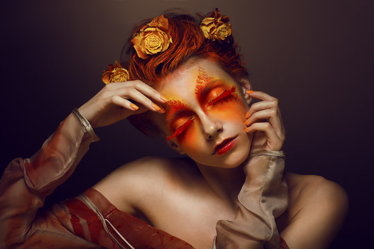 Bodyart. Artistic Woman. Red - Gold Makeup and Flowers. Coloring