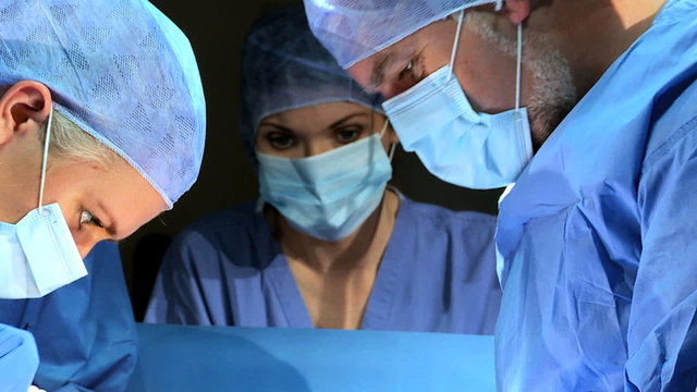 Specialized Team Performing Surgery in Operating Room Close Up