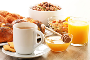 Breakfast including coffee, bread, honey, orange juice, muesli a