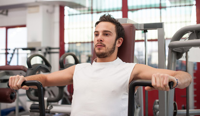 Fototapeta na wymiar Young man training in the gym.