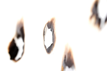 Fototapeta na wymiar burned hole on a white paper background