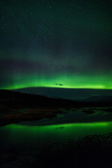 Northern lights above lagoon in Iceland