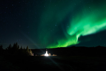 Northern lights above a church in Iceland
