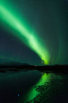 Northern lights above lagoon in Iceland